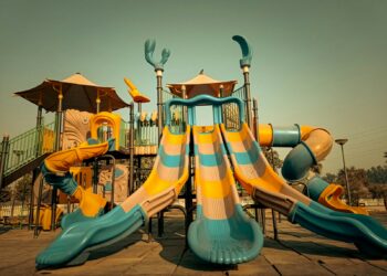a playground with a slide and a play structure