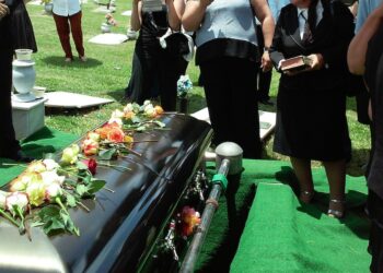 people in front of a coffin