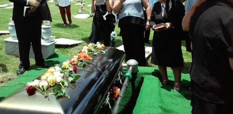 people in front of a coffin