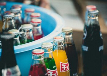 closeup of soda bottles beside basin