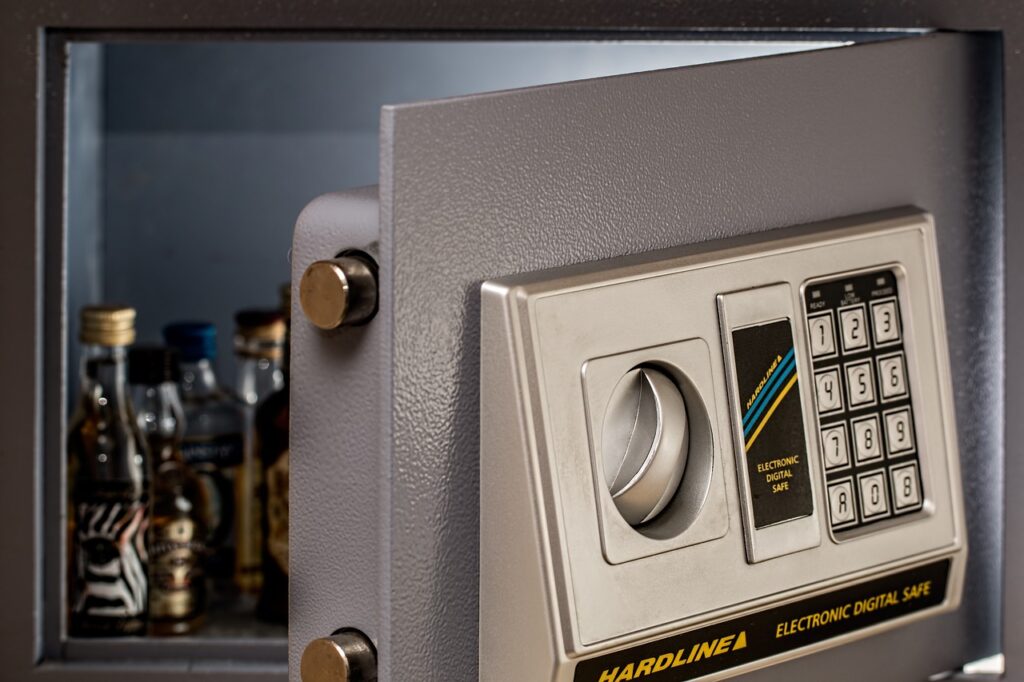 a wall safe slightly open revealing coins inside