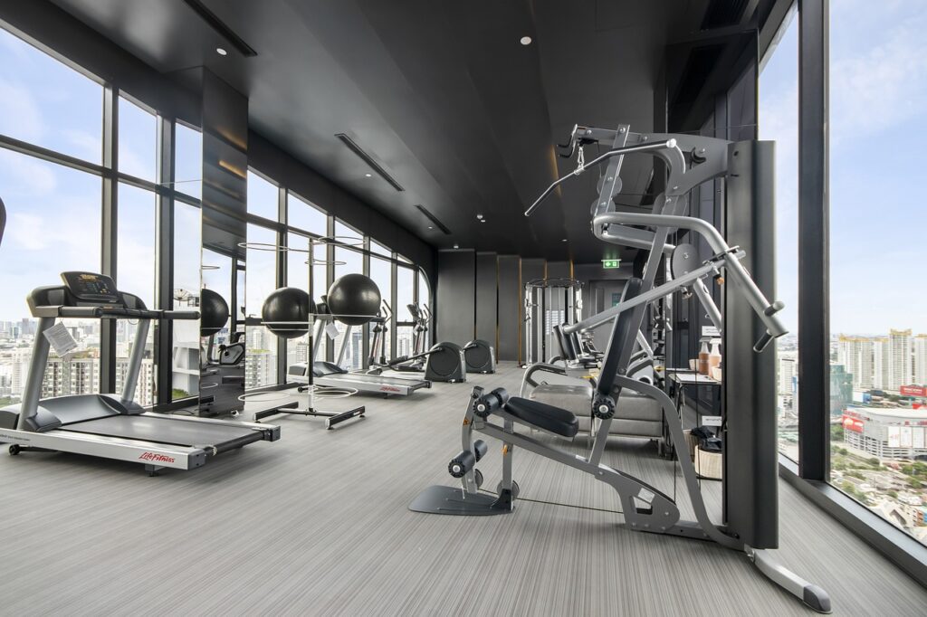 gym equipment in front of large windows