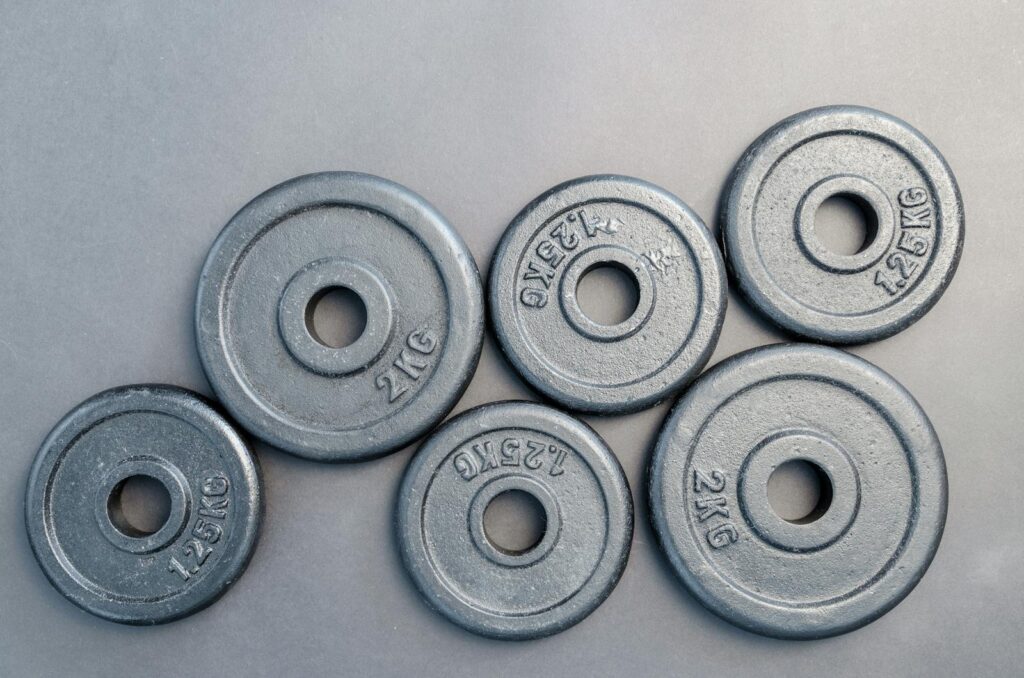 Six Assorted Weight Plates on the ground