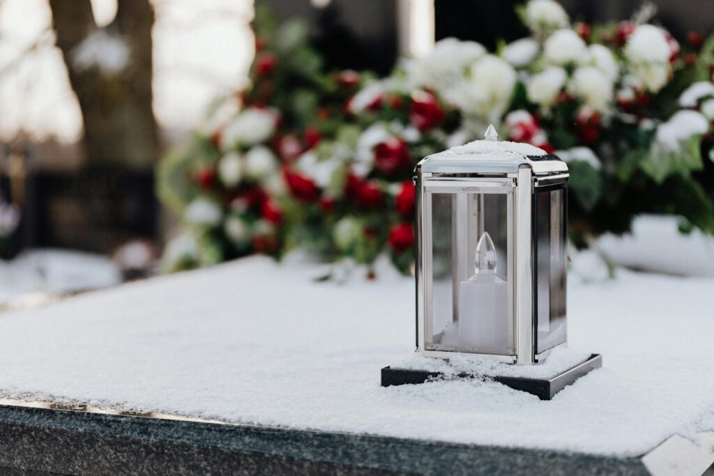 Clear Glass Candle Holder on Snow Covered Tomb