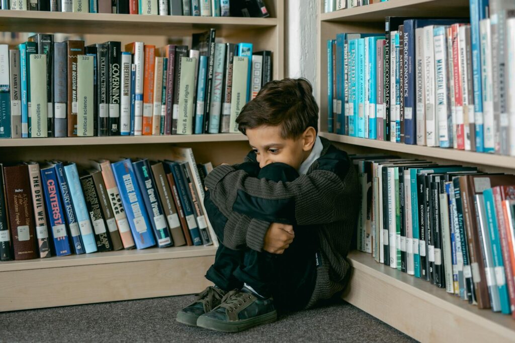 Boy Sitting in a Library