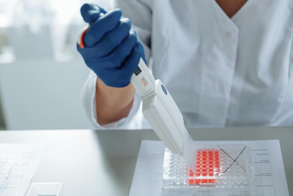 Close-up of a Lab Worker Distributing Medication into Capsules
