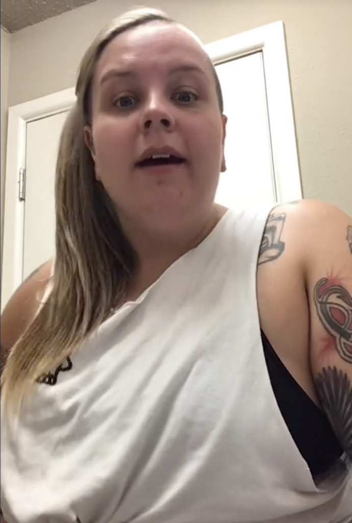 woman standing in front of camera speaking