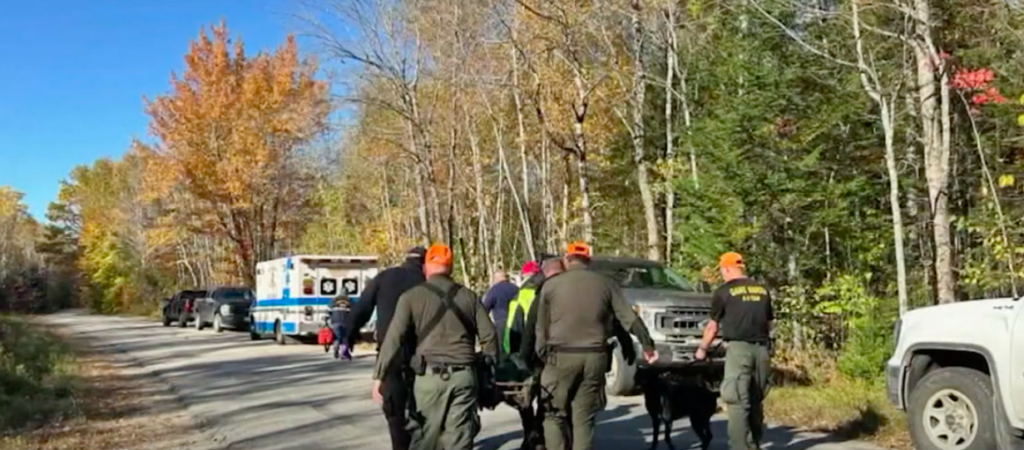 Rescuers in Maine transport a hiker to an ambulance