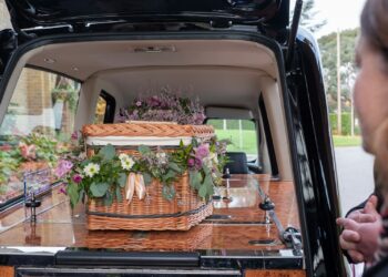 the back of a van with flowers in the trunk