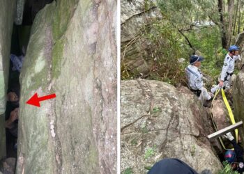 Woman being rescued from a rock crevasse