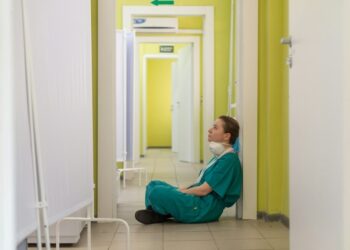 nurse sitting on the ground in the hospital
