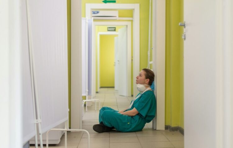 nurse sitting on the ground in the hospital