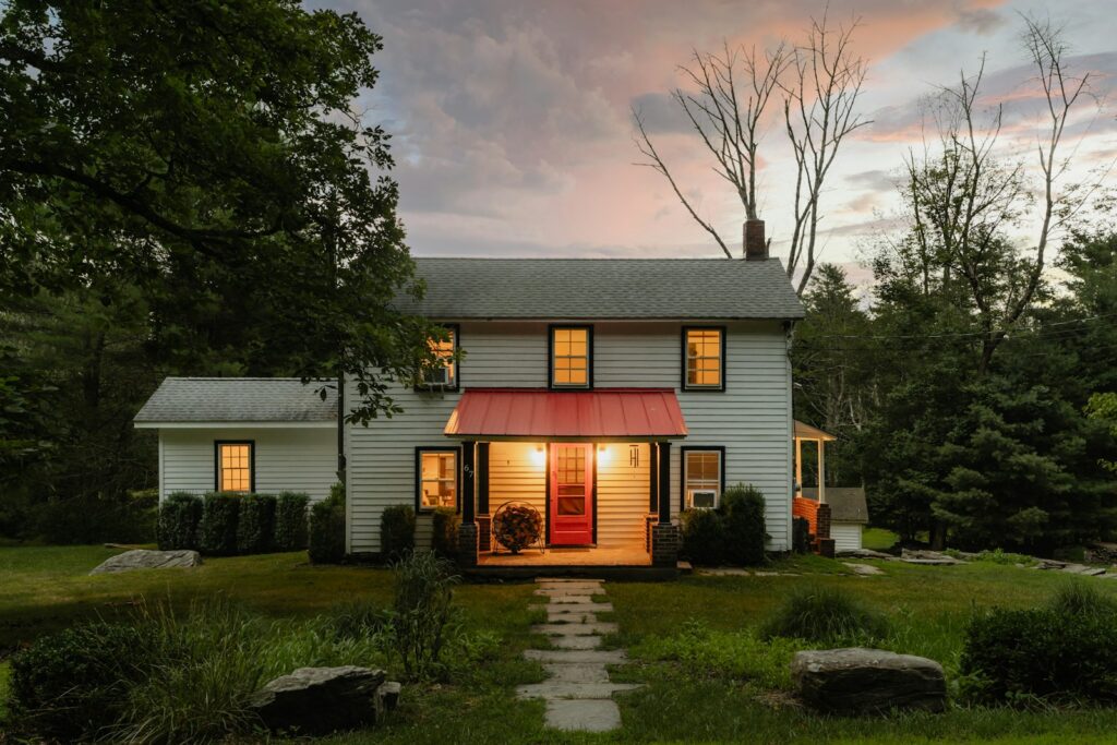 A small white house with a red awning