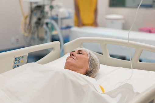 Mature patient lying on hospital gurney at operating room