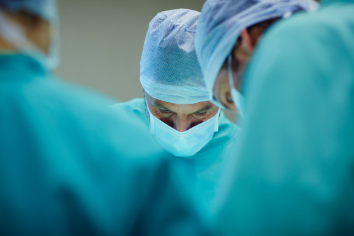 Surgeons working in operating room
