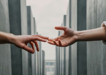 Two hands touching for support (Toa Heftiba via Unspalsh)