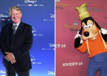 Goofy smiles happily in a vibrant background, as Bill Farmer, his voice actor, shares insights on Goofy being a unique species.
