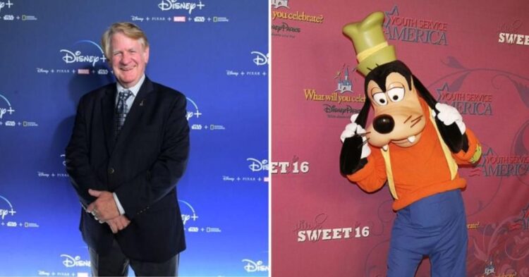 Goofy smiles happily in a vibrant background, as Bill Farmer, his voice actor, shares insights on Goofy being a unique species.