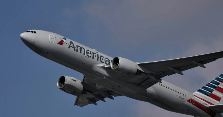 white and red passenger plane flying in the sky during daytime