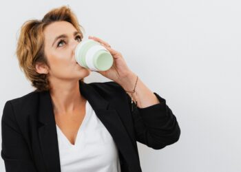 woman sipping on coffer from a tumbler