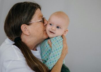 Grandmother kissing baby