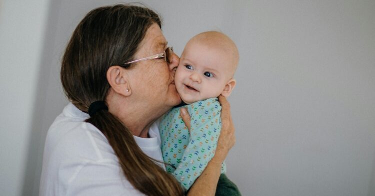Grandmother kissing baby