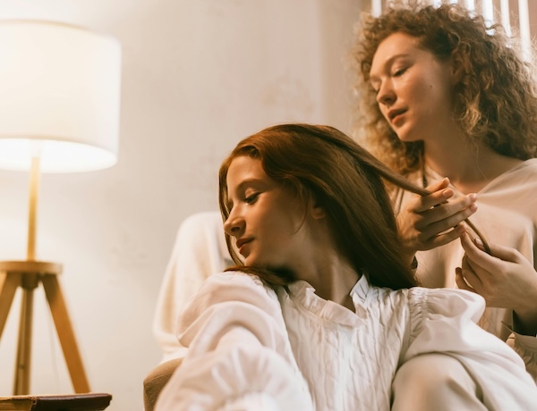 mother brushing daughters hair