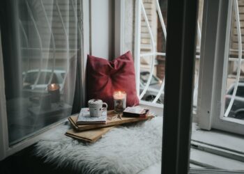 photo of gel candle on board beside pillow