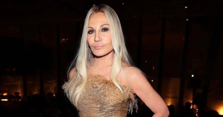 Designer Donnatella Versace poses in a gold gown
