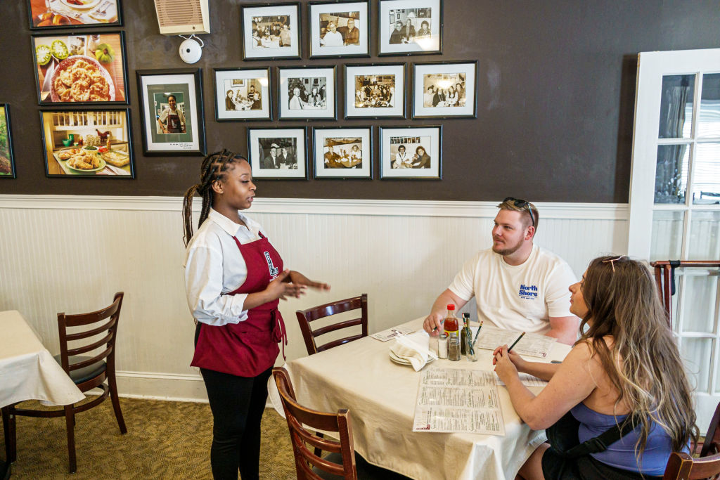 Atlanta, Georgia, Mary Mac's Tea Room restaurant, waitress, helping customers couple