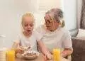 A joyful morning meal shared by a grandmother and granddaughter, showcasing family love.