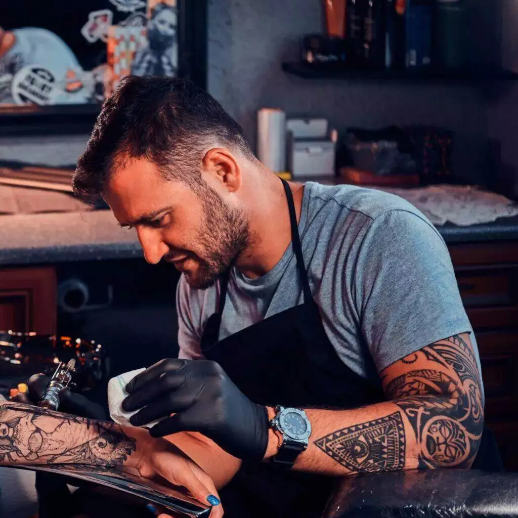 tattoo artist working