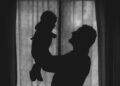 Father holding baby (Unsplash | Alfonso Scarpa)