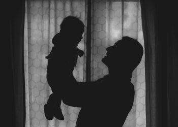 Father holding baby (Unsplash | Alfonso Scarpa)