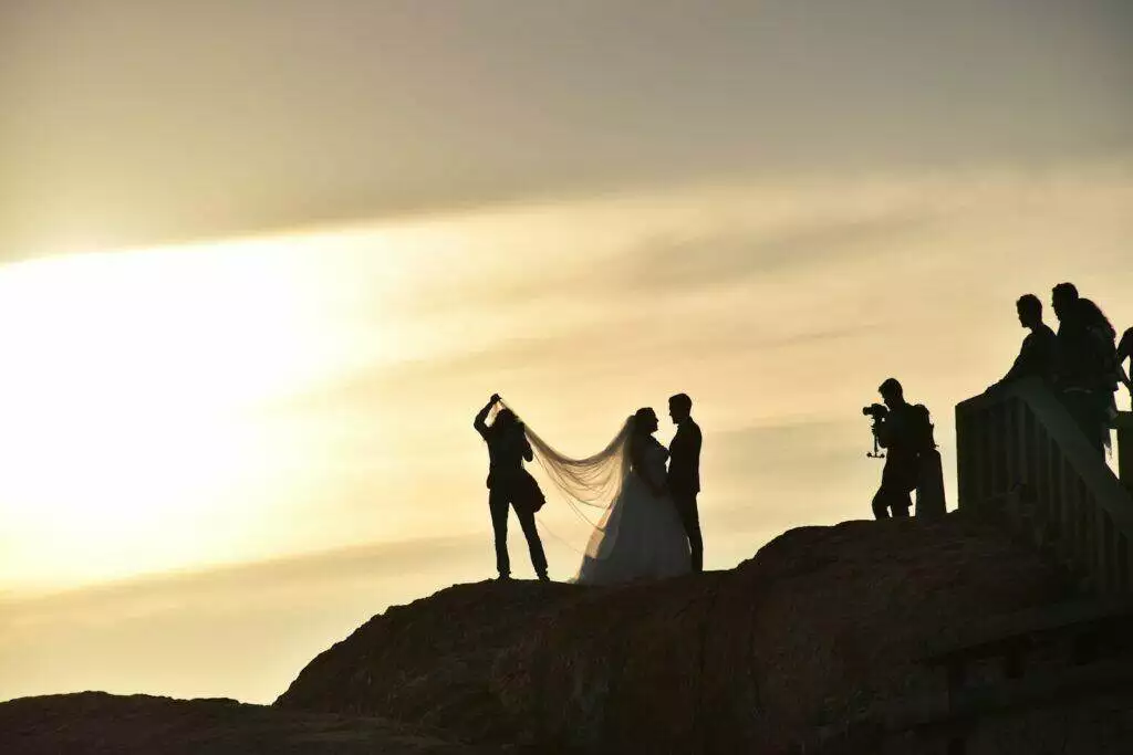 wedded couple on boulder