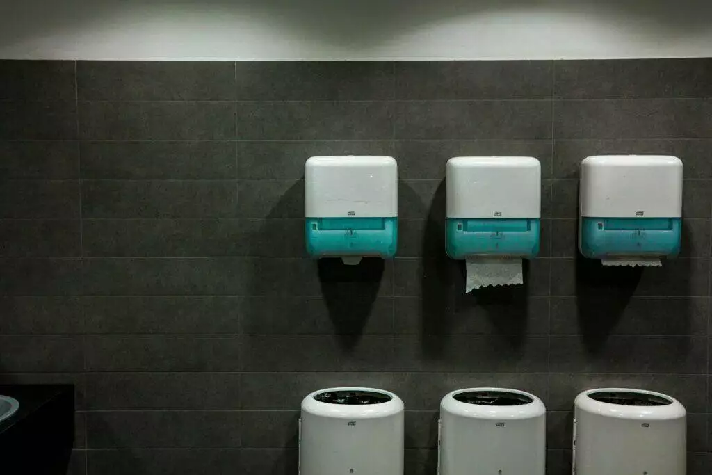 white toilet paper roll on white toilet paper holder