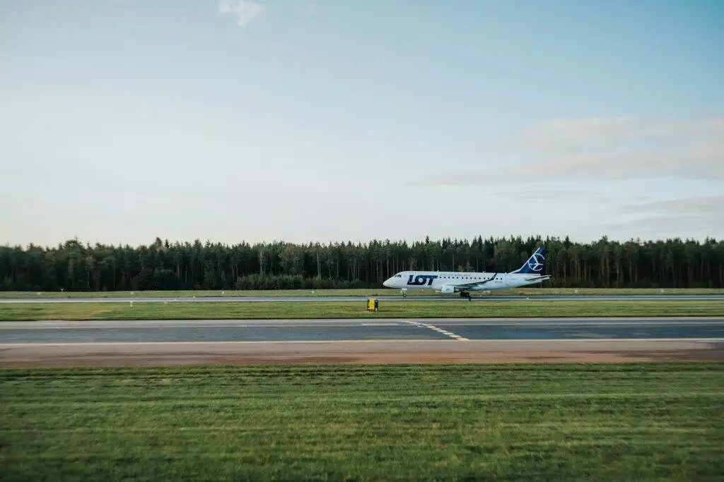 white plane near green grass field