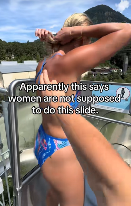 Screenshot of video of diver getting ready to get into the slide with the text over it: