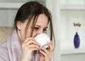 Woman sitting in a chari drinking from a mug (Unsplash | Bermix Studio)