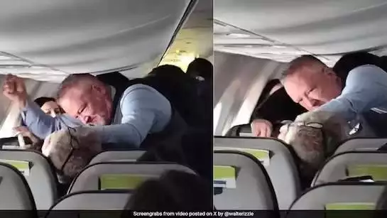 An Alaska Airlines flight attendant punches an unruly passenger in the throat and torso to force him to let go of a woman’s hair.