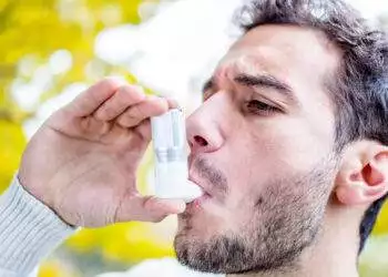 Guy using inhaler