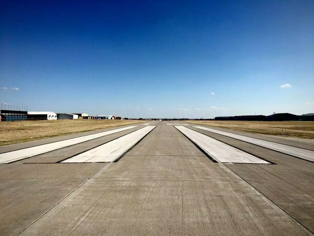 gray asphalt road under blue sky during daytime