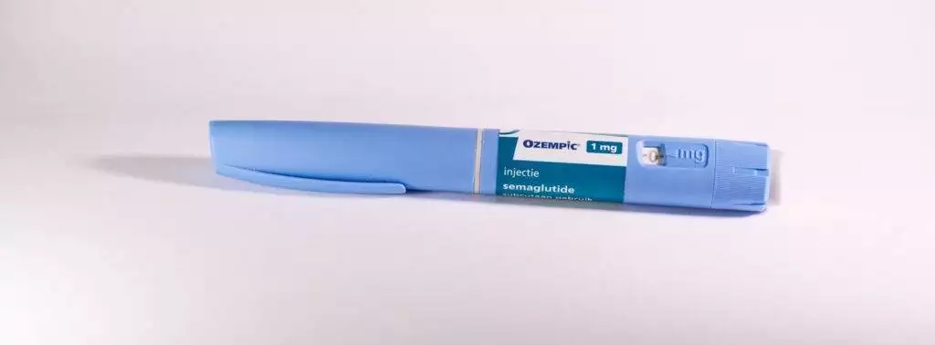 A blue pen sitting on top of a white table