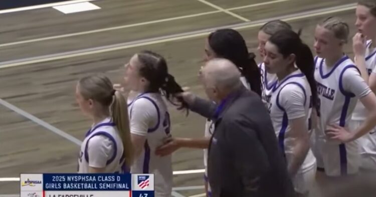 Screenshot from video showing high school basketball coach pulling player's hair