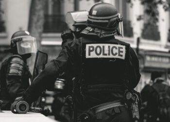 Black and white image of police officer in uniform