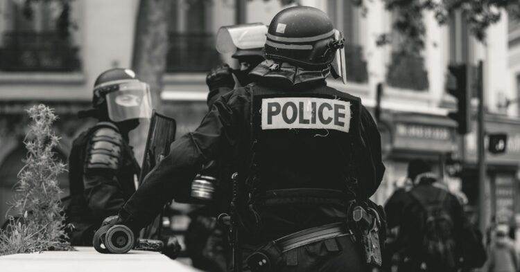 Black and white image of police officer in uniform