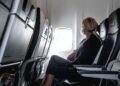 Woman sitting in plane seat near window