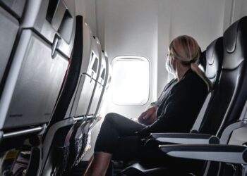 Woman sitting in plane seat near window