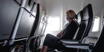 Woman sitting in plane seat near window