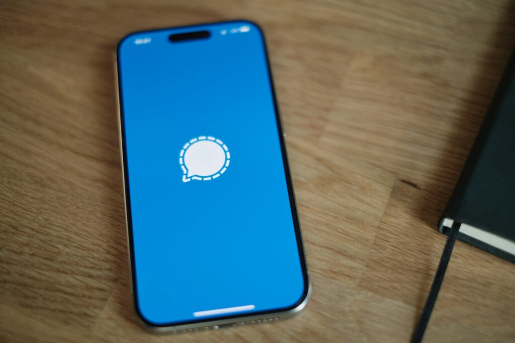 A cell phone sitting on top of a wooden table